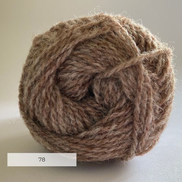 Close up of the end of a ball of wool in a soft marled brown