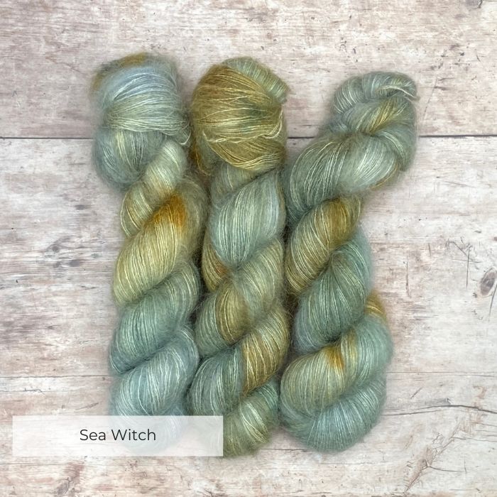 Three skeins of Mohair Lace in watery shades of blue and green with splashes of golden yellow