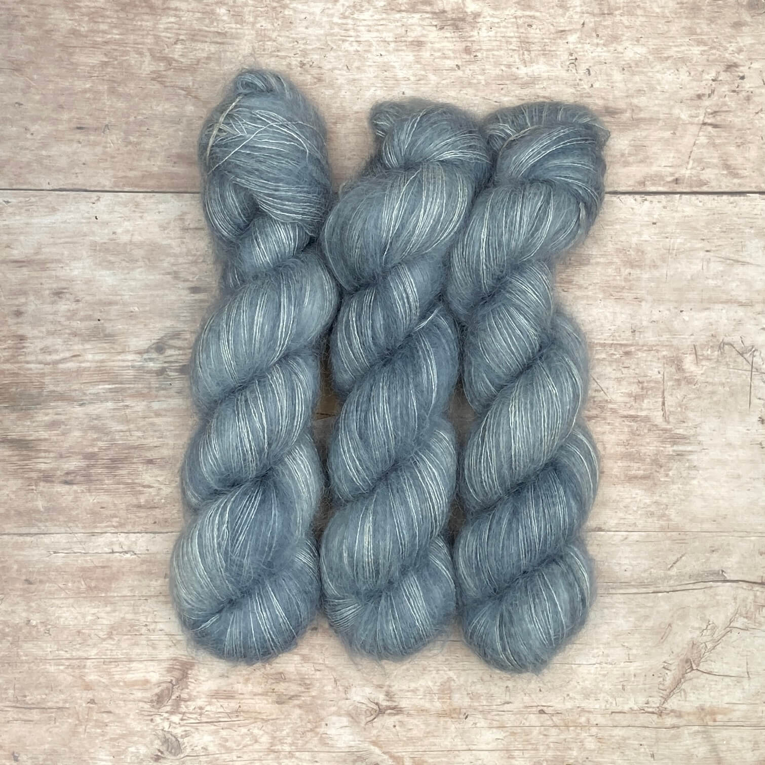 Three skeins of mohair & silk lace in a pale grey blue