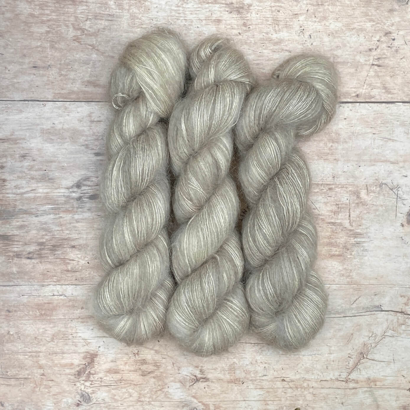 Two plump skeins of soft grey mohair and silk lace
