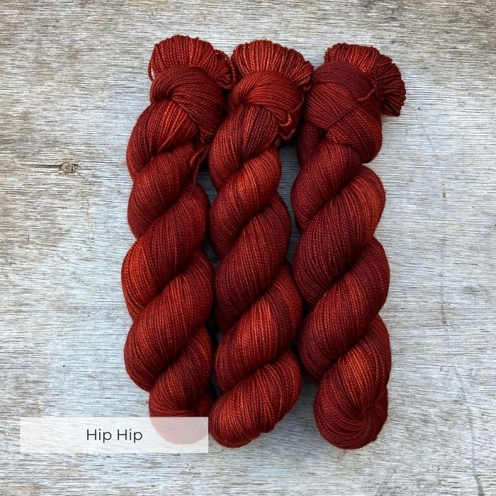 Three skeins of a deep dark red yarn