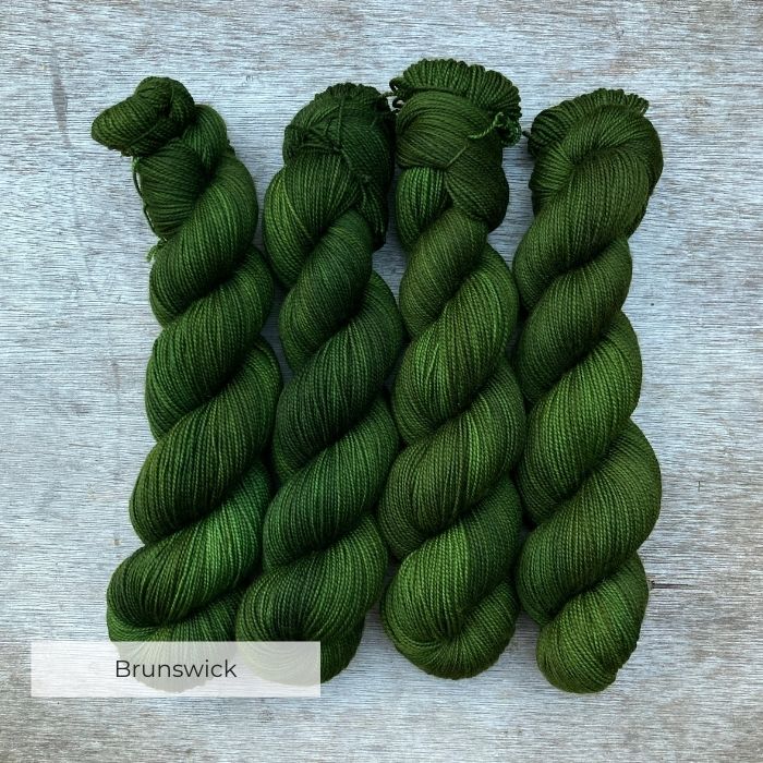 Four skeins of dark grass green yarn
