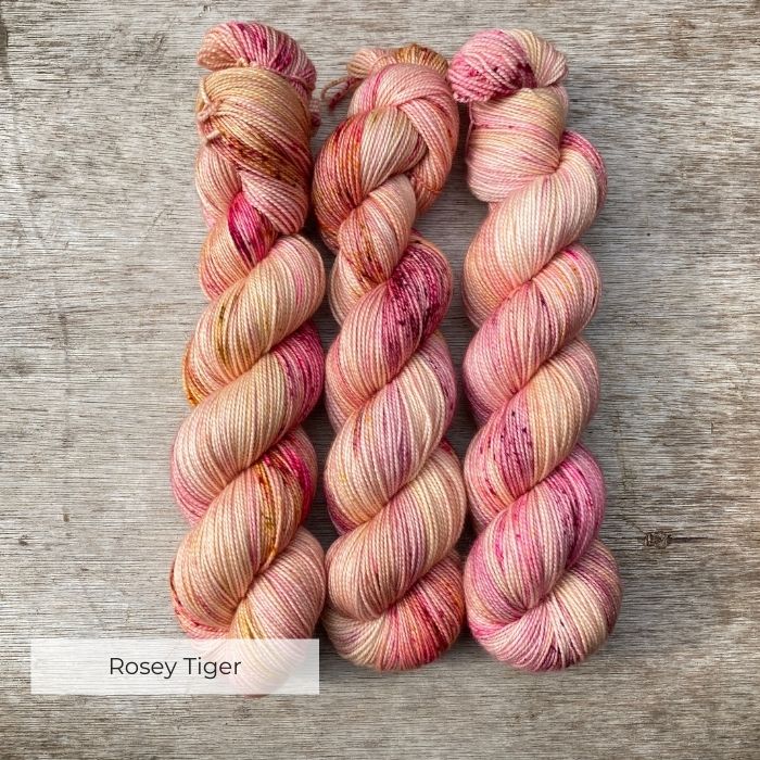 Creamy yellow yarn heaven speckled with dark red and pinks