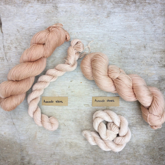 Four skeins of yarn showing the different colours achieved with avocado dye