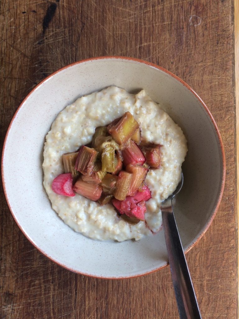A bowl of porridge topped with rhubarb