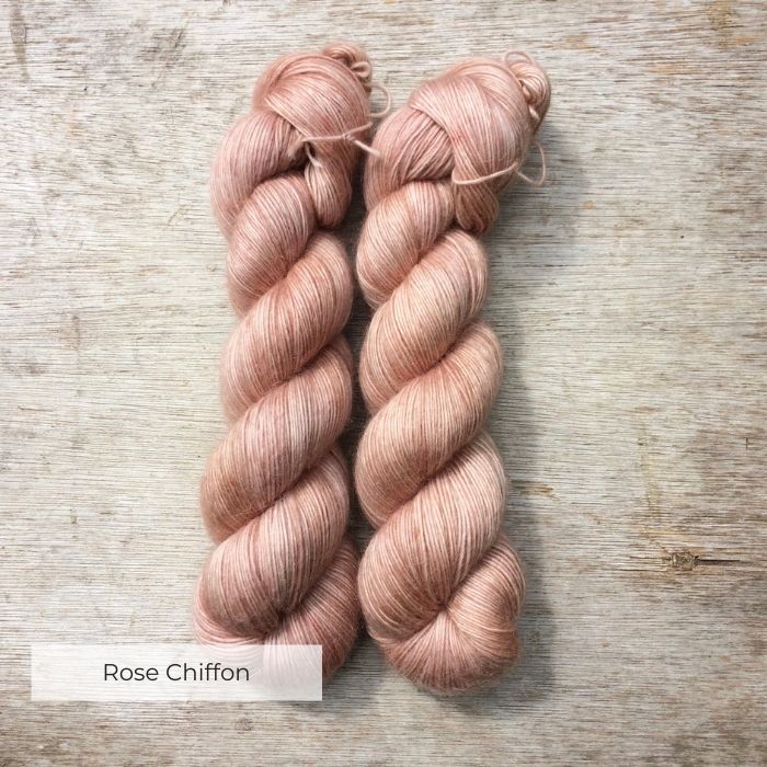 Two skeins of soft, fluffy peachy pink yarn