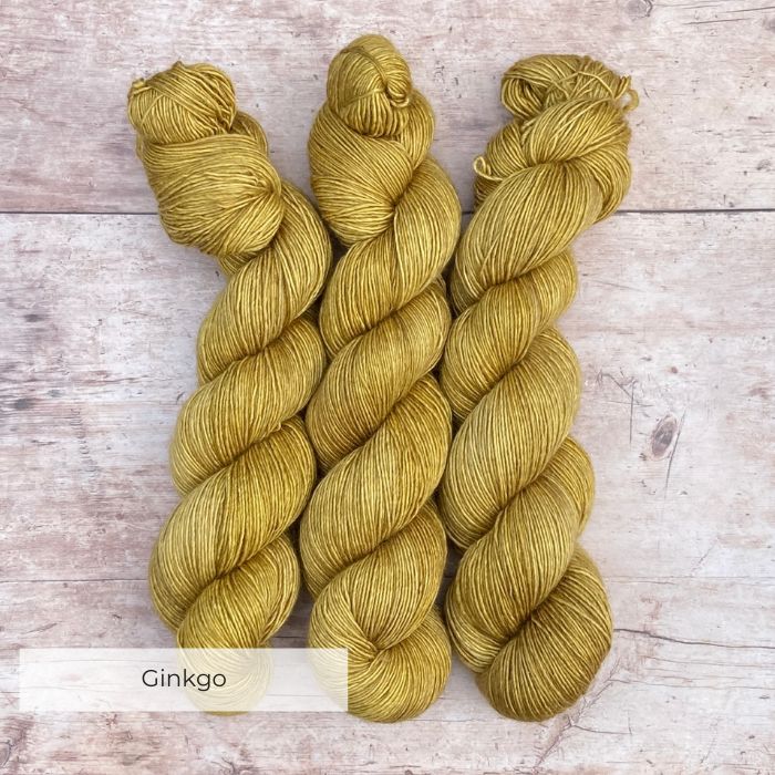 Three skeins of Merino & Silk Single in a light mustard