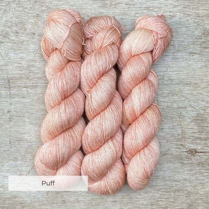 Three skeins of the softest pink with faint yellow speckles