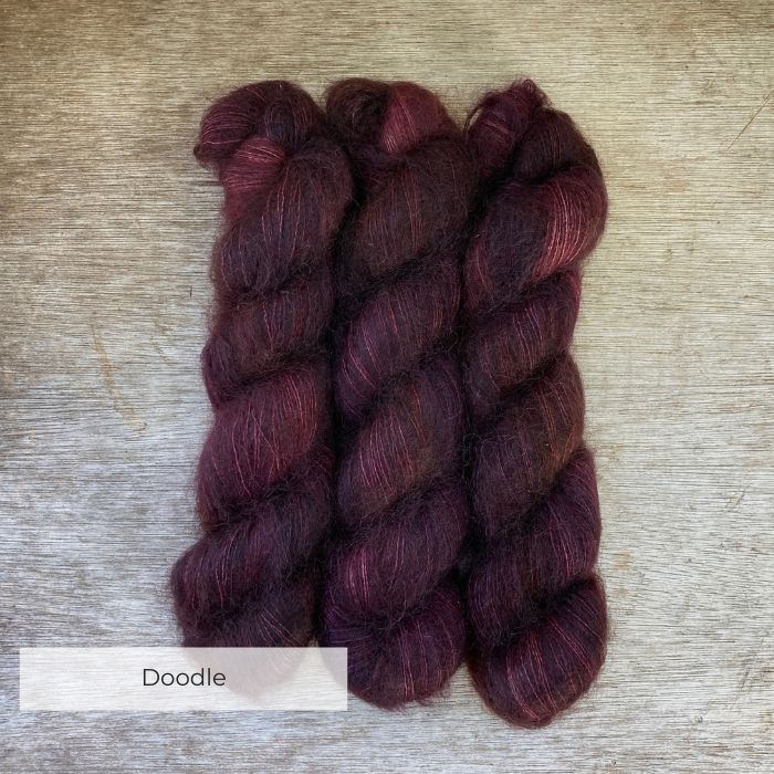 Three skeins of mohair and silk lace in deep brown, plum purple