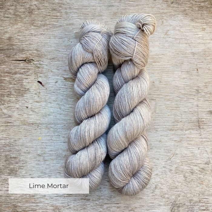 Two soft skeins of silky pale grey yarn