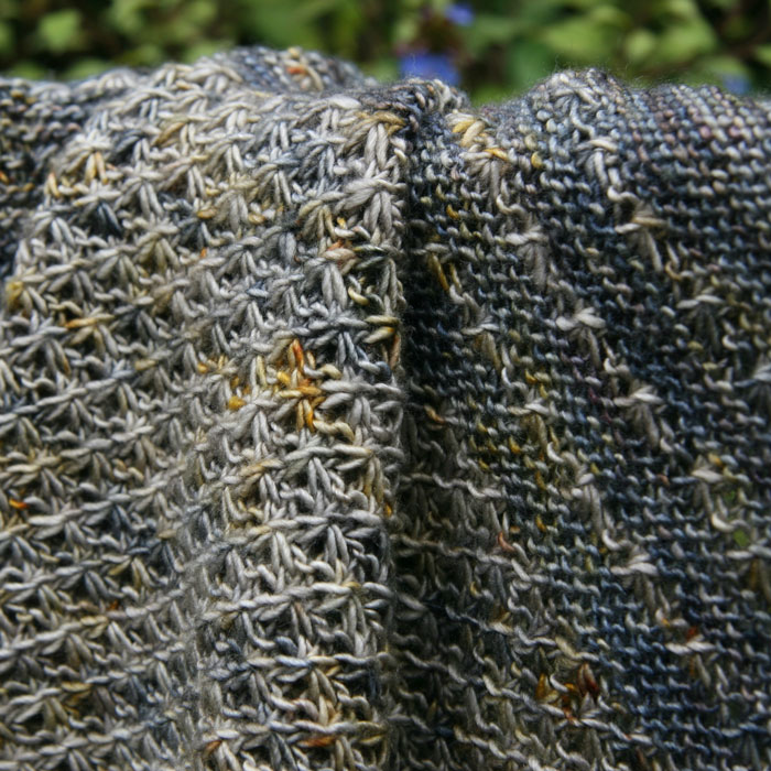 Close up of a shawl showing off the changes of colour of the yarn