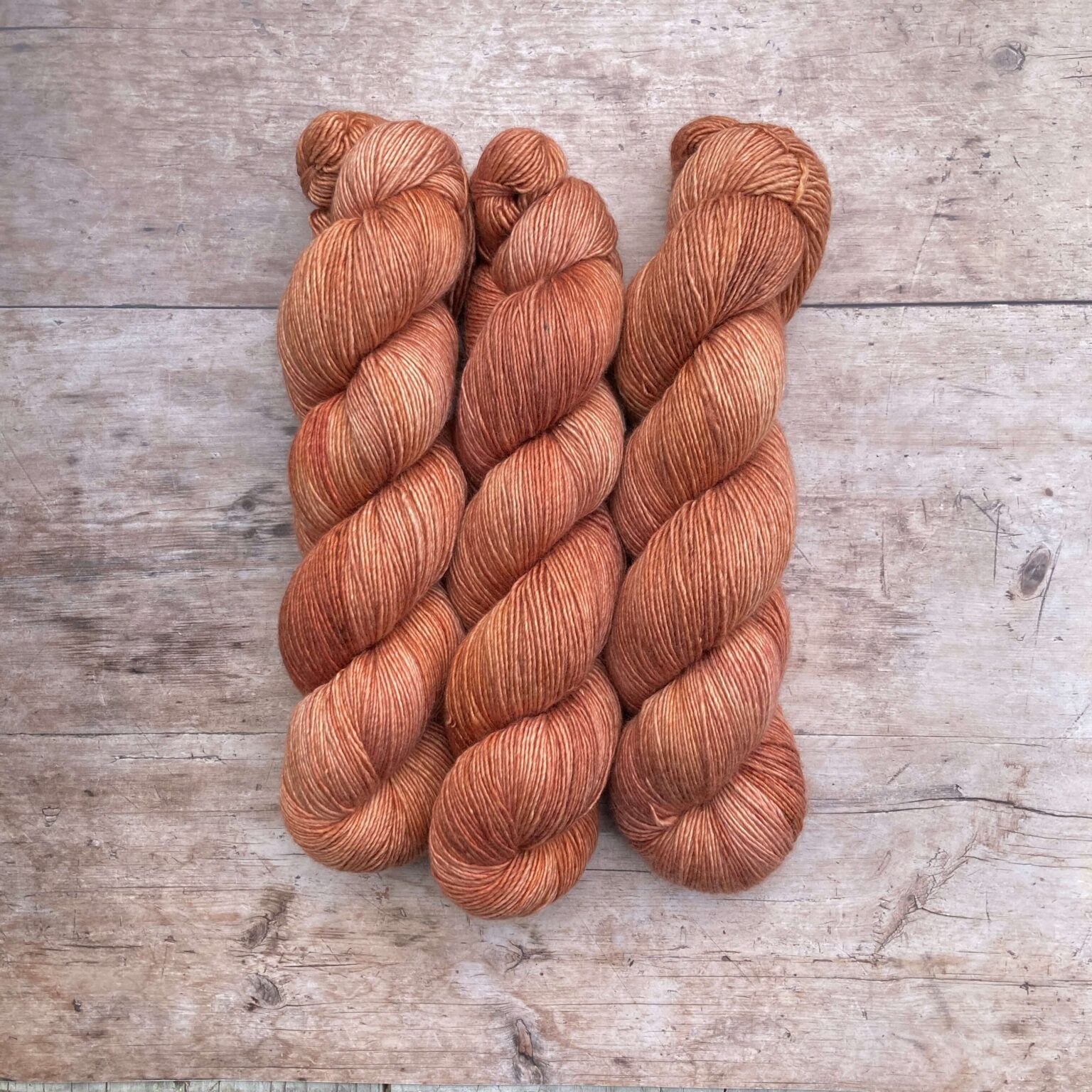 Two skeins of Merino & Silk in a pale terracotta