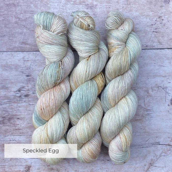 Three skeins of Merino & Silk in palest pink, blue and cream. Lightly speckled in gold