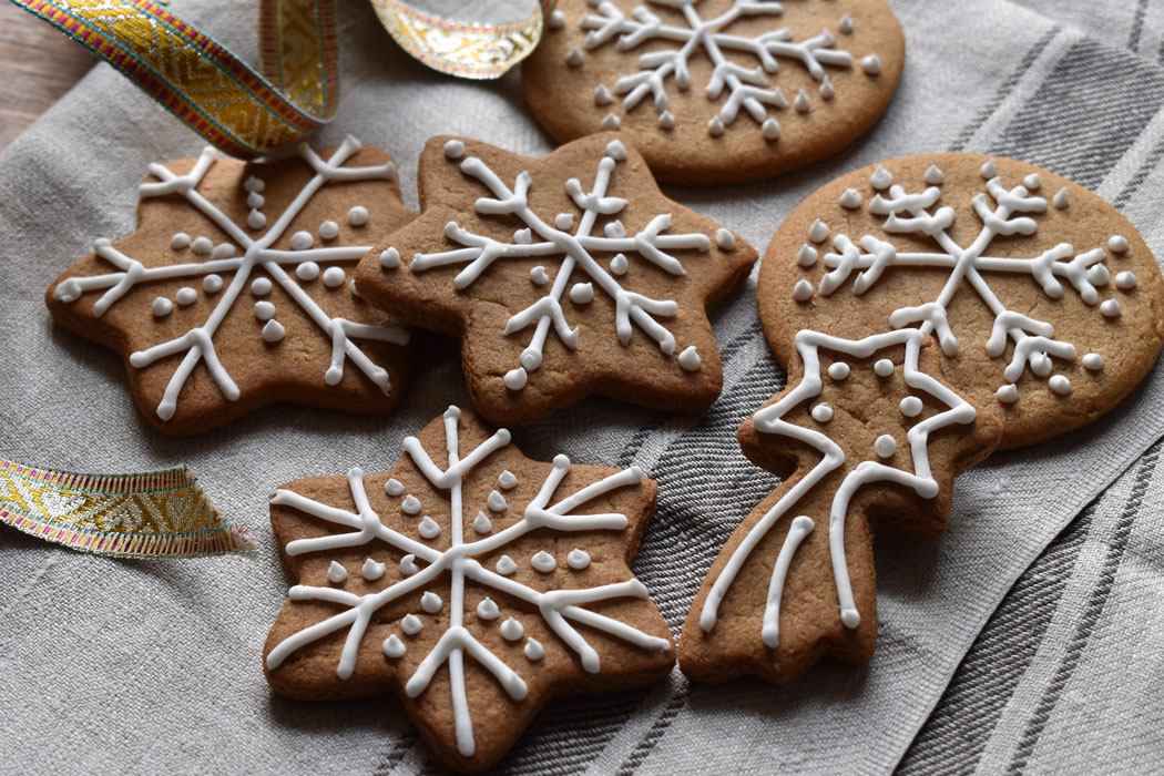 Iced gingerbread snowflakes and stars on a teatowel