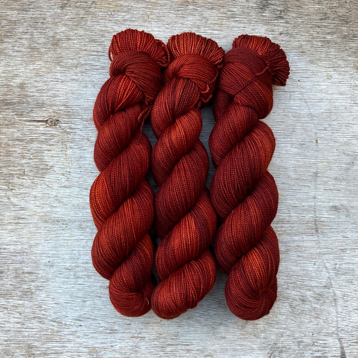 Three skeins of a deep dark red yarn