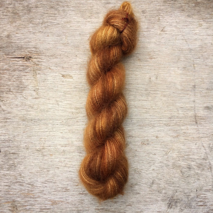 A single plump skein of mohair and silk in shades of caramel and toffee