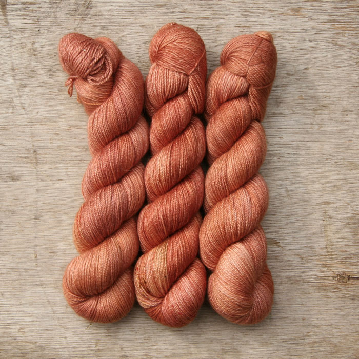 The skeins of soft, silky terracotta alpaca yarn
