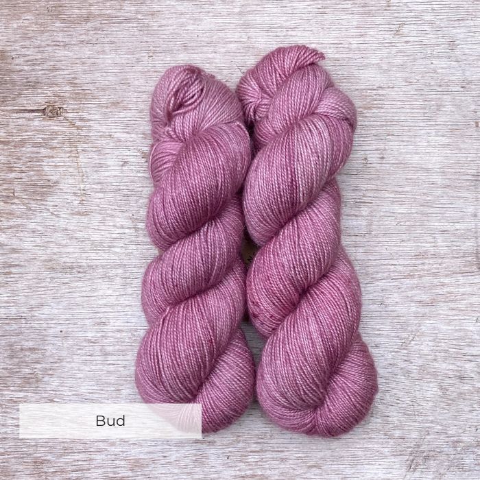 Two plump skeins of pink yarn