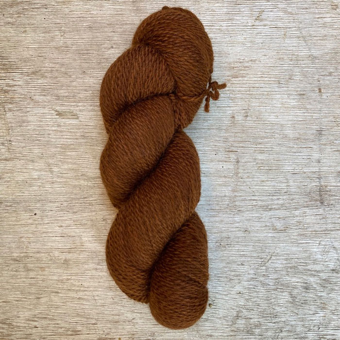 A single skein of British wool in a rich coppery bronze
