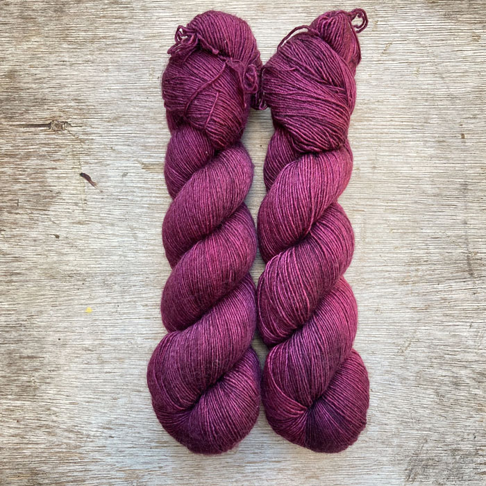 Two skeins of dark pink red wool