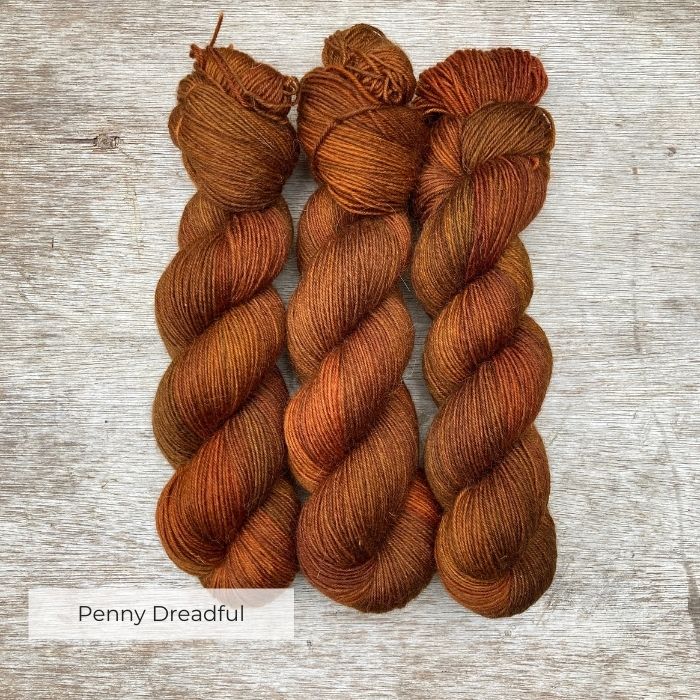 Three skeins of orange coppery yarn