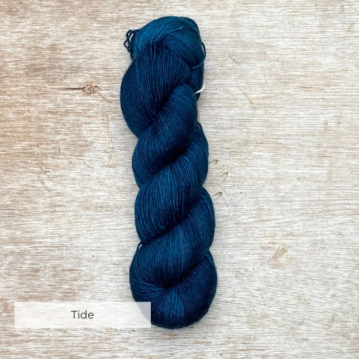 A single skein of deep teal yarn