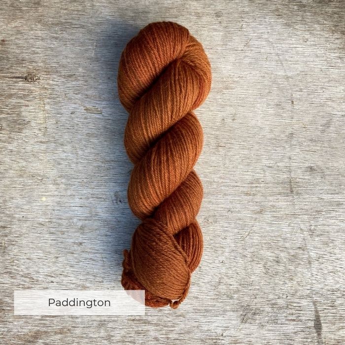 A single plump skein of dark marmalade coloured yarn