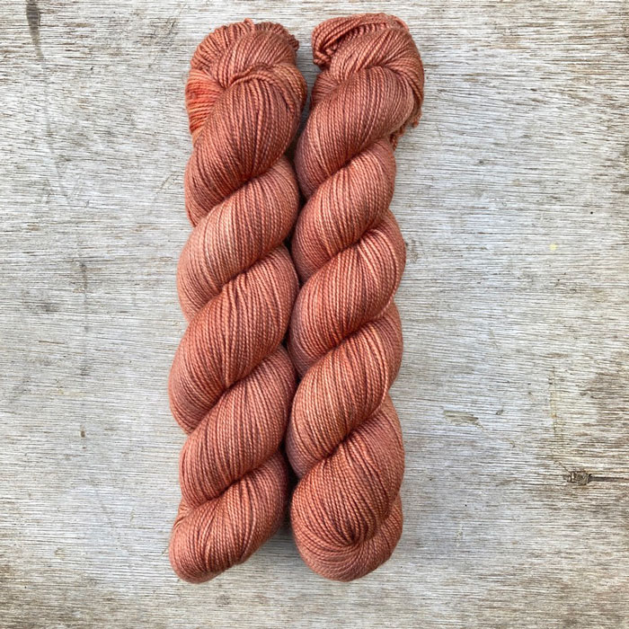 Two skeins of pale terracotta yarn