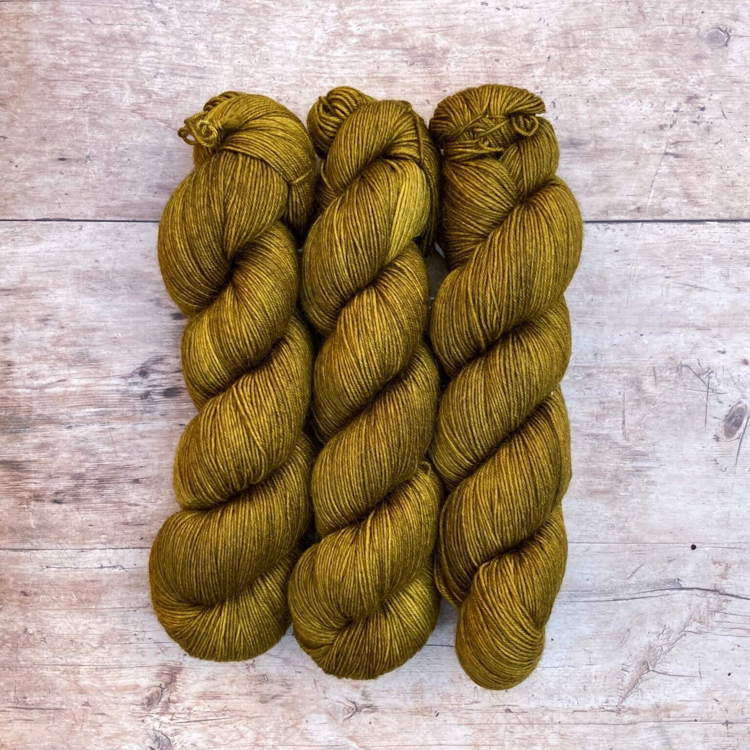 Three skeins of Mohair Sock in a yellow green khaki