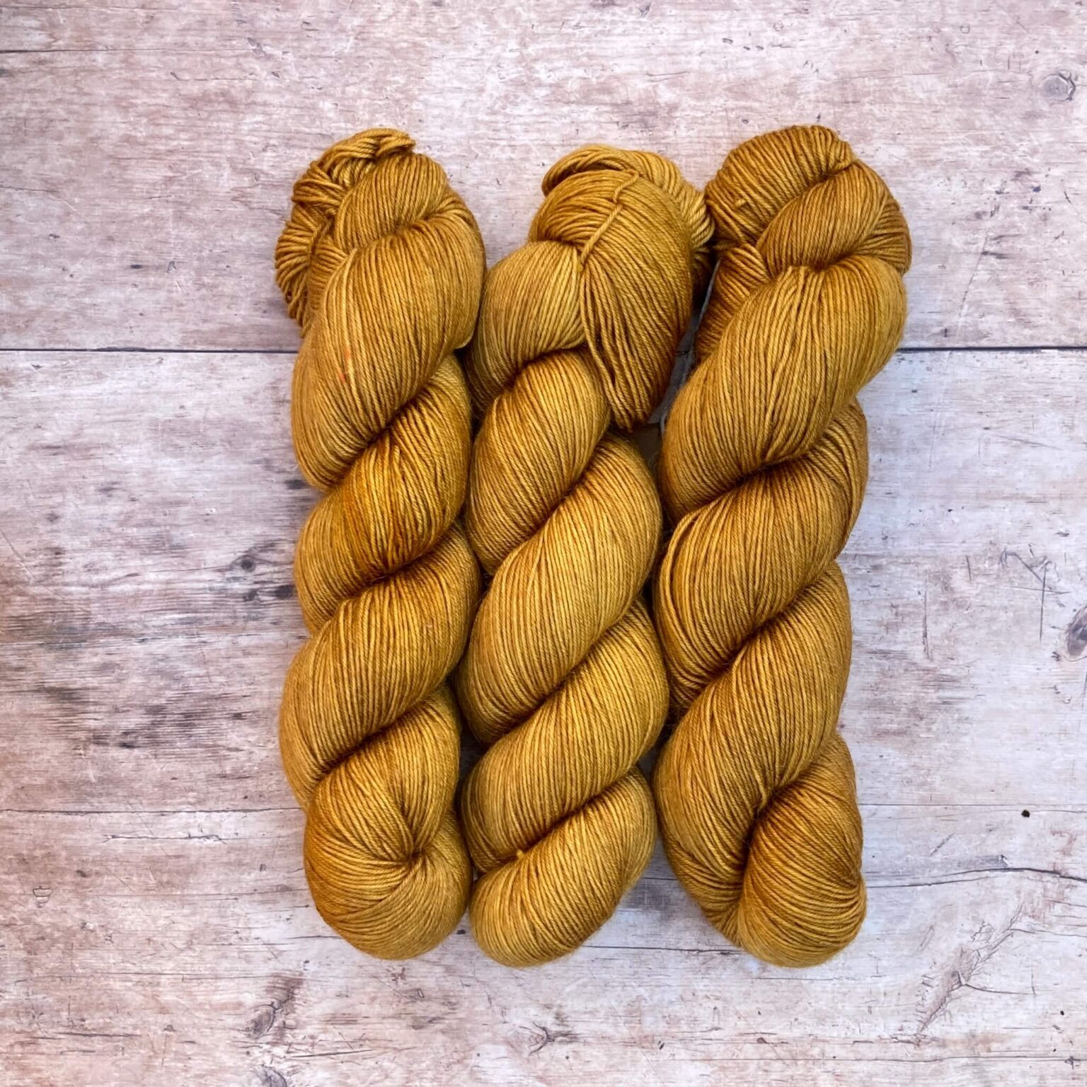 Three skeins of Mohair Sock in a deep golden ochre