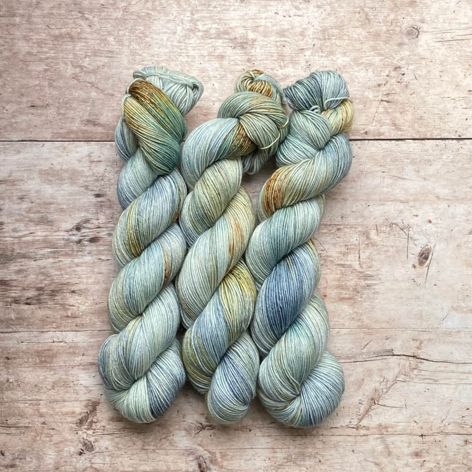 Three skeins of Mohair Sock in pale blue green with splashes of yellow