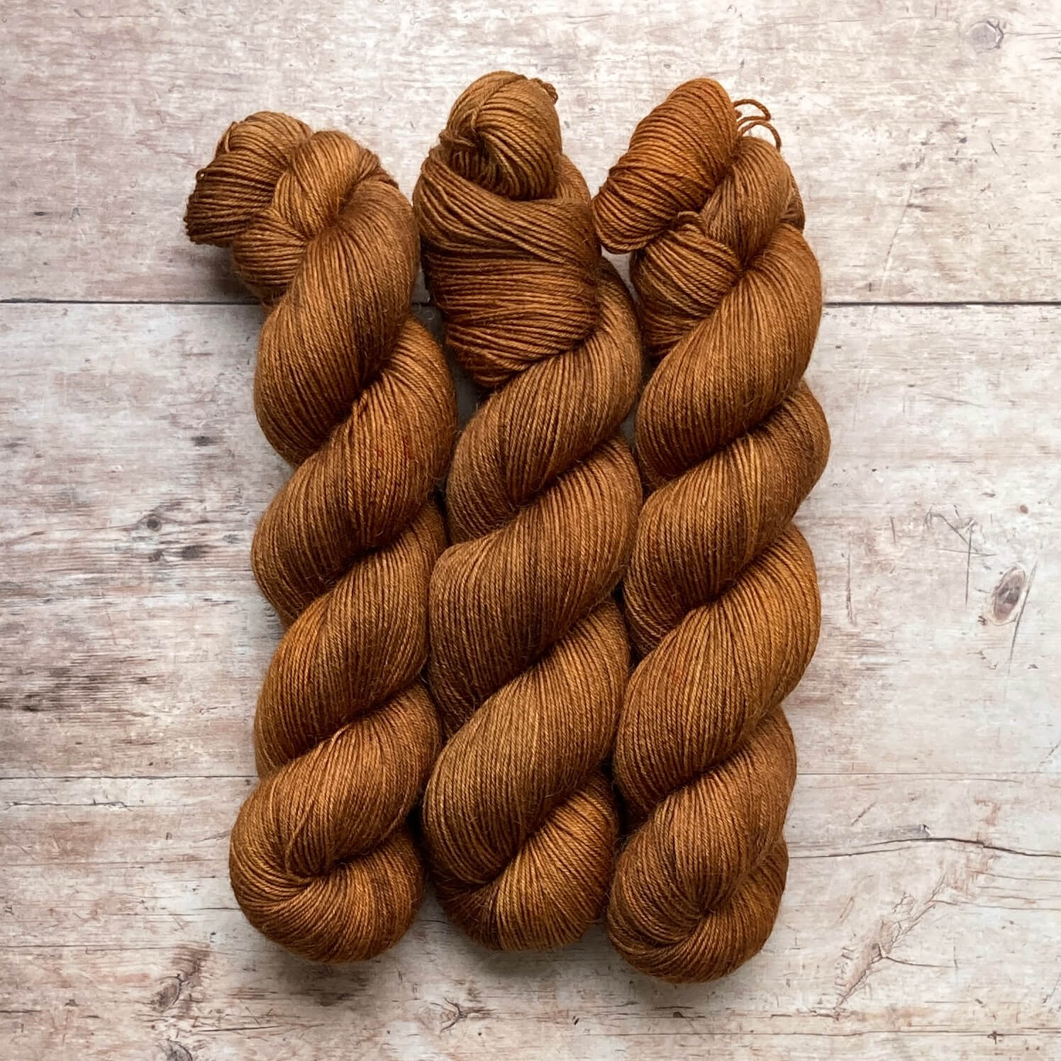 Three skeins of Mohair Sock in shades of amber, gold and toffee