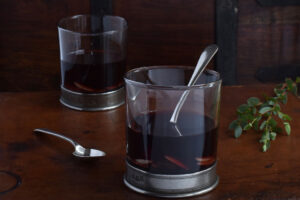 Two glasses of glogg on an old suitcase