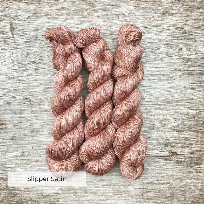 Three silky soft skeins of alpaca in a peachy pink