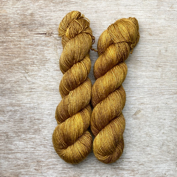 Two skeins of deep golden ochre yarn