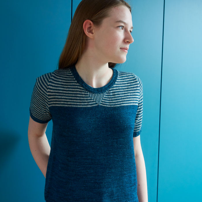 A girl wearing a short sleeved striped t-shirt