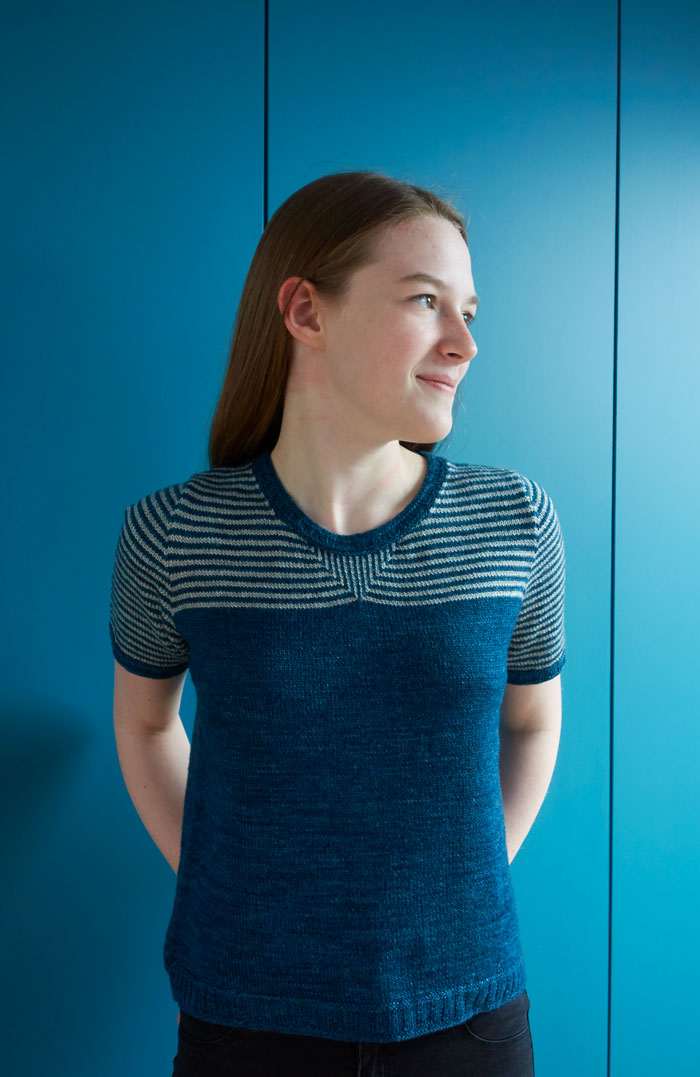 A girl wearing a short sleeved striped t-shirt