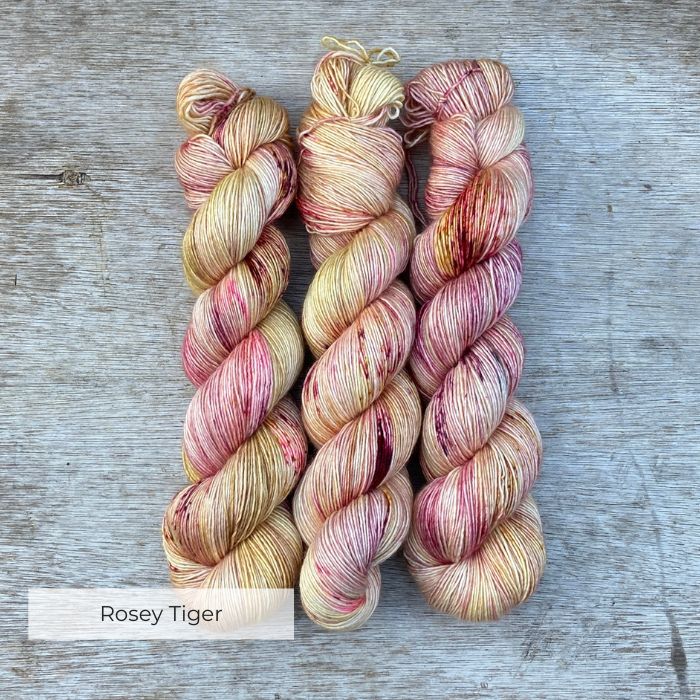 Creamy yellow yarn heaven speckled with dark red and pinks