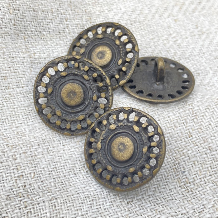 Four metal shank buttons with a pierced design