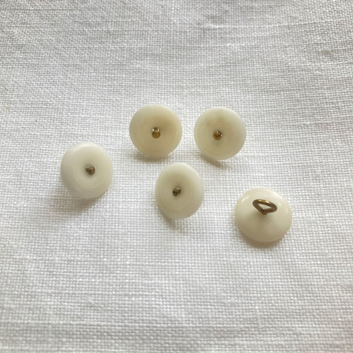 Five 12mm white corozo buttons with a bronze metal shank