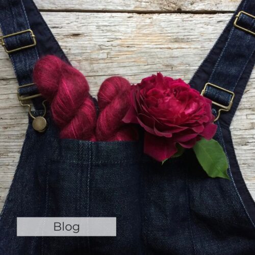 A pair of dungarees the pocket filled with roses an yarn