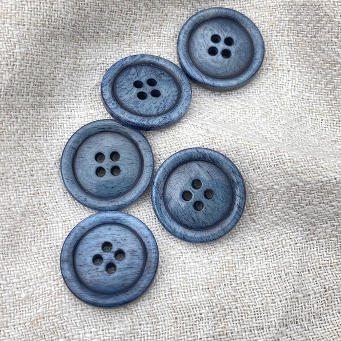 A scattering of denim blue buttons