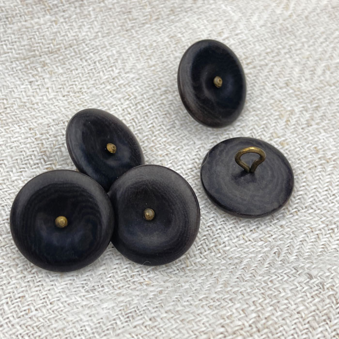 Five dark grey buttons with a bronze metal shank