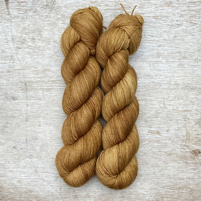 Two skeins of deep golden yarn