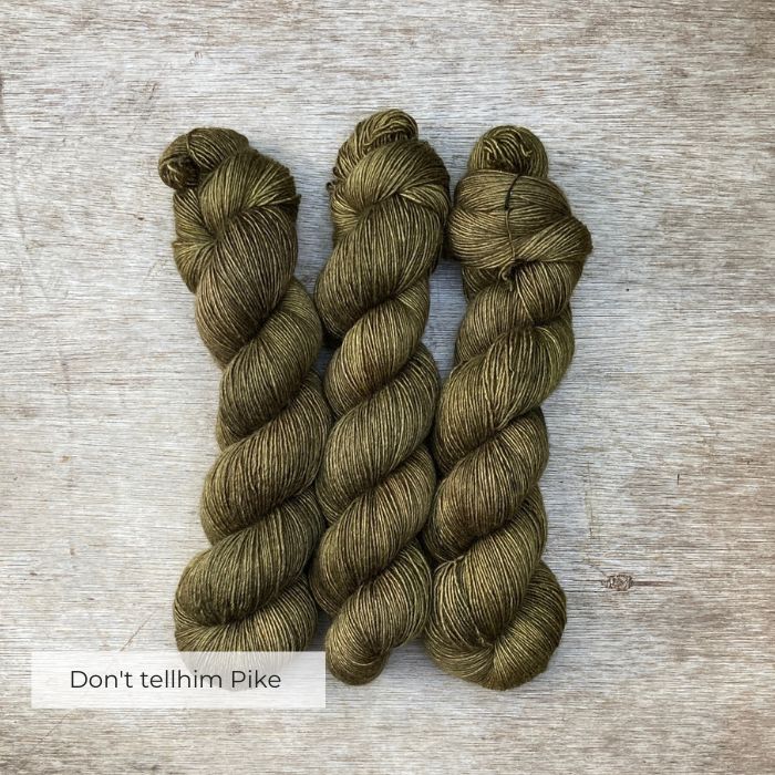 Three skeins of yarn in a dark classic Khaki