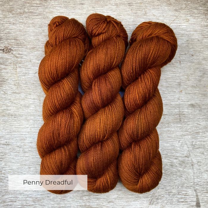 Three skeins of orange coppery yarn