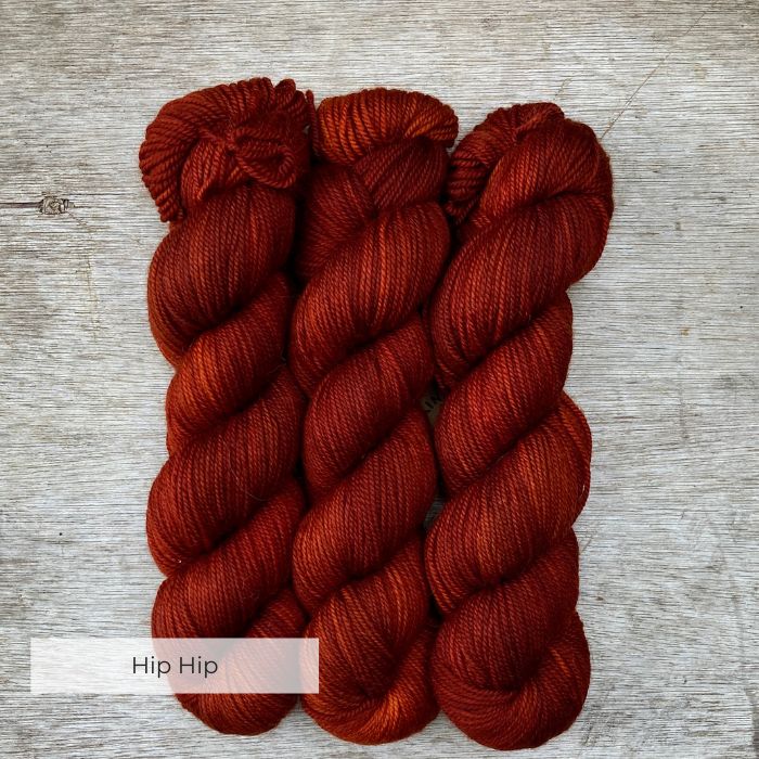 Three skeins of a deep dark red yarn
