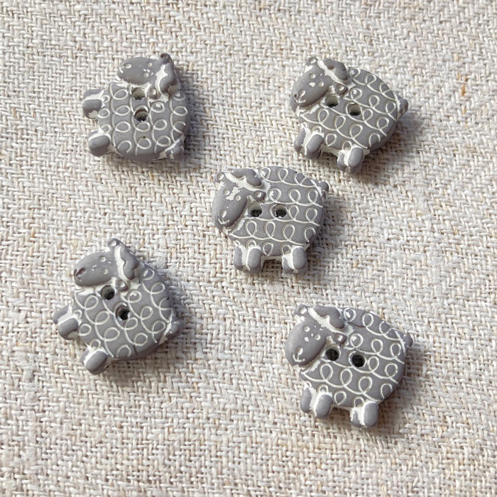 Five grey sheep buttons