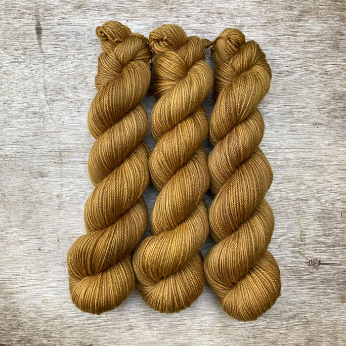 Three skeins of of golden mustard wool