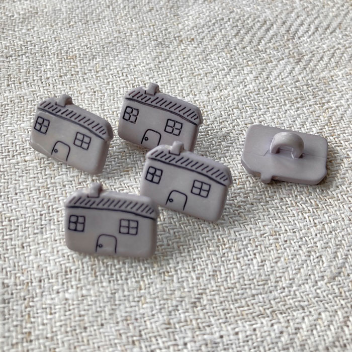 Five grey buttons in the shape of small houses